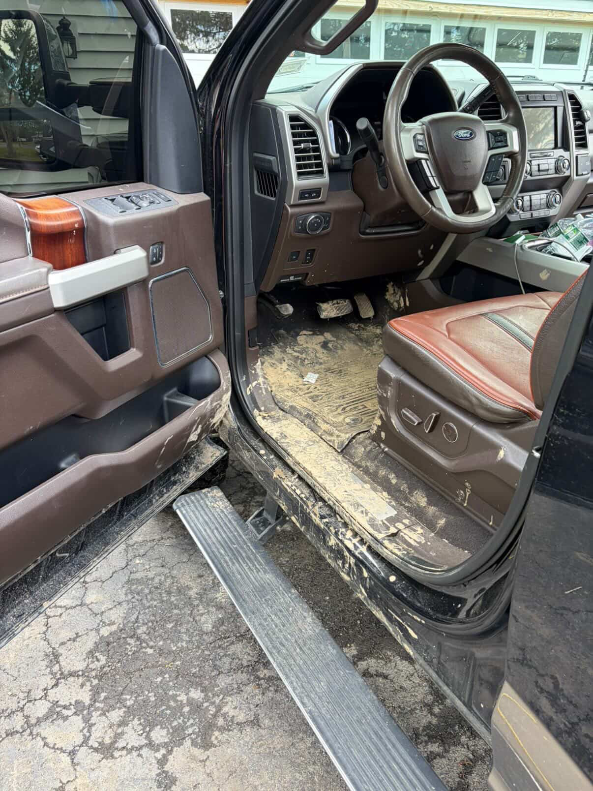 Truck interior caked with dried mud before detailing